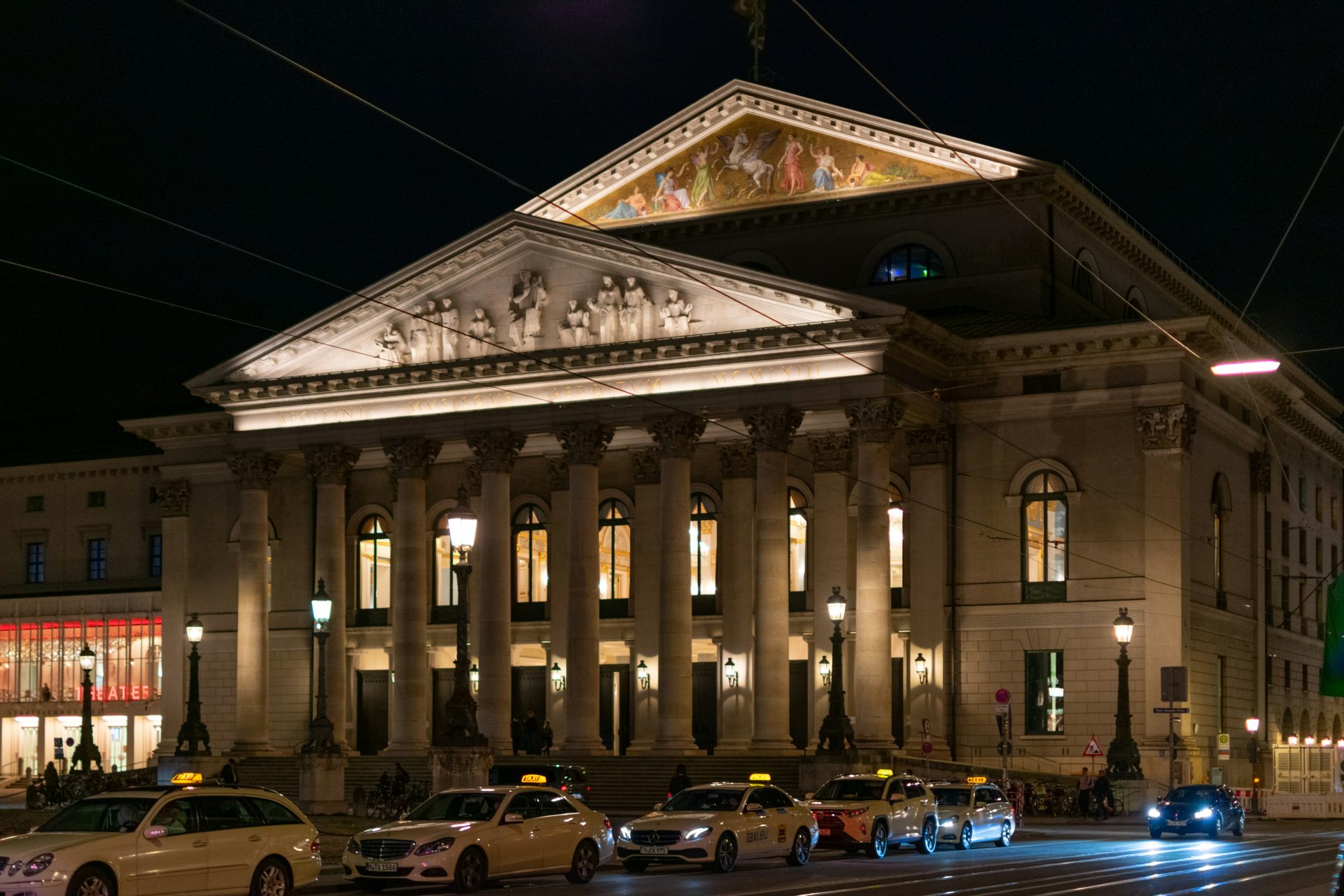 a large building with a lot of cars parked in front of it
